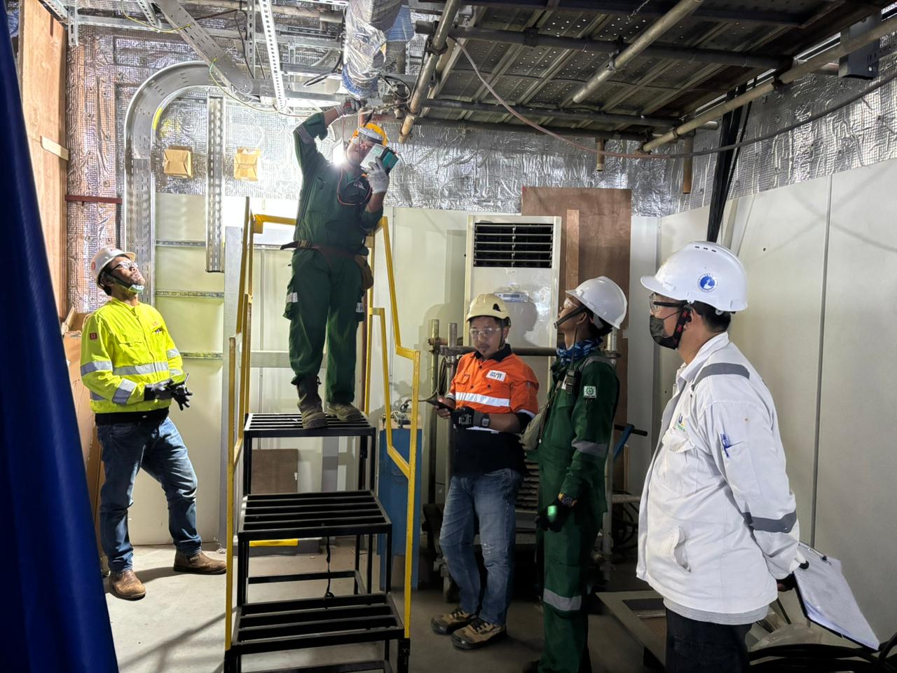 Technician working overhead on cable tray installation