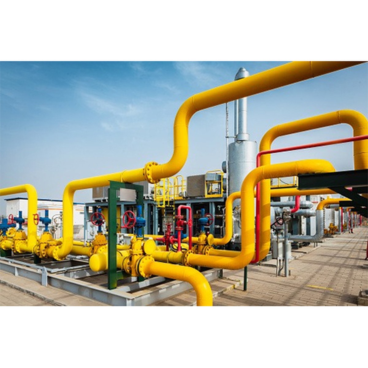 Yellow-coated pipe rack with valves at an industrial plant — Bars, Pipes and Sheets category hero image